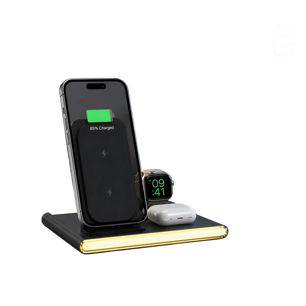 A wireless charging pad on a bedside table charging a smartphone, smartwatch, and earbud case in a modern bedroom setting. Text on the image reads 'POWER YOUR ESSENTIALS' and 'Fast wireless charging for phone, watch and earbuds'.